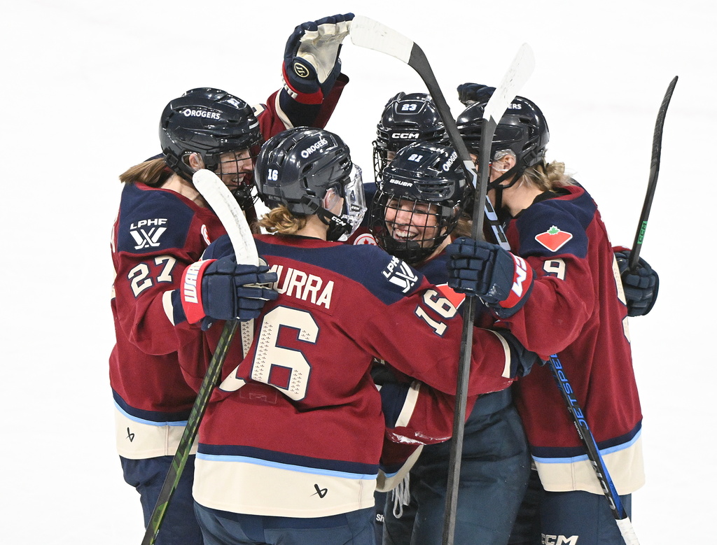 Montreal Victoire's Maureen Murphy (21) celebrates with teammates Hayley Scamurra (16) Shiann Darkangelo (27), Erin Ambrose (23) and Kati Tabin (9) after scoring against the Ottawa Charge during first period PWHL hockey action in Laval, Quebec, Canada, Saturday, Jan. 24, 2026. (Graham Hughes/The Canadian Press via AP)