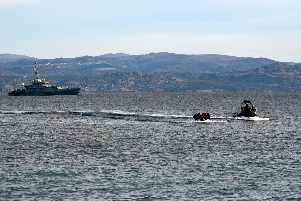 FILE - In this Friday, Feb. 28, 2020 file photo, refugees and migrants arrive in a dinghy accompanied by Frontex vessels at the village of Skala Sikaminias, on the Greek island of Lesbos, after crossing the Aegean sea from Turkey. AP Photo/Michael Varaklas, File)