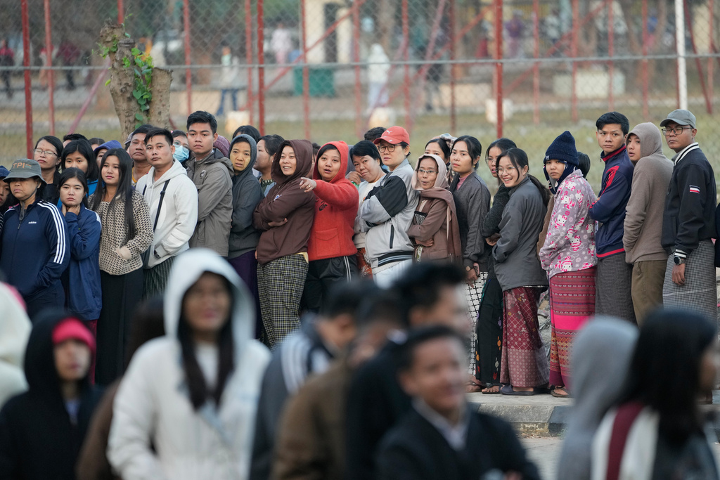 Voters line up to cast their ballots at a polling station in Naypyitaw, Myanmar, Sunday, Dec. 28, 2025. (AP Photo/Aung Shine Oo)