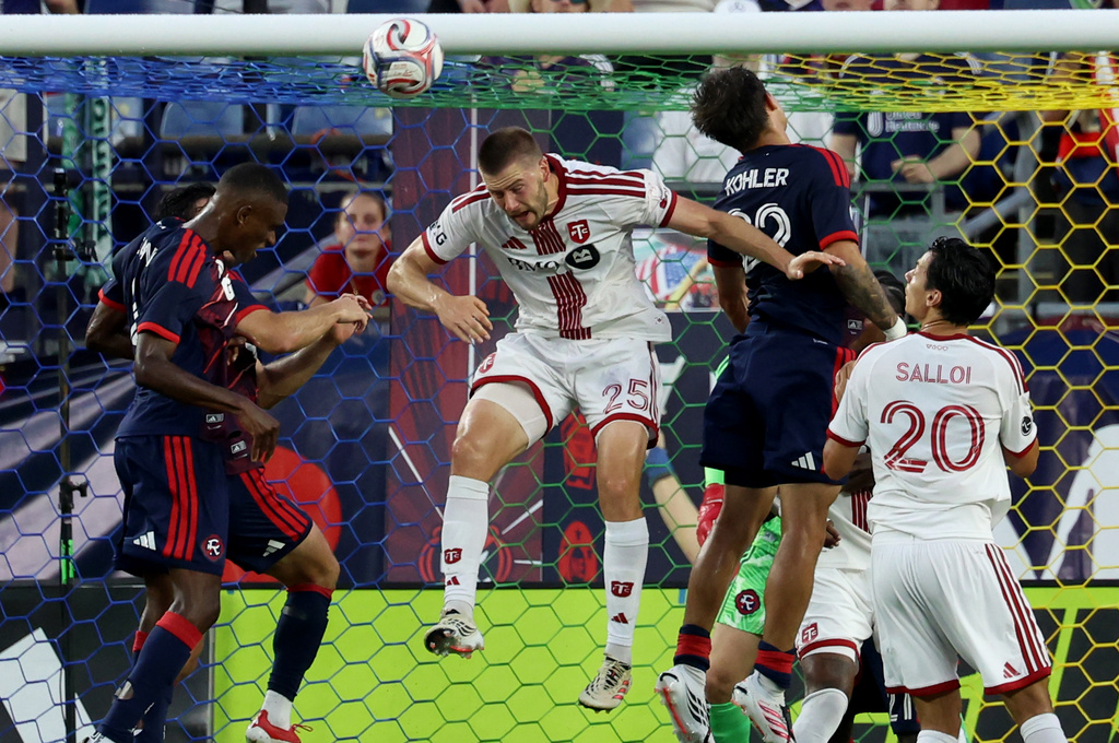Toronto FC's Walker Zimmerman (25) heads the ball on a corner kick in the first half of an MLS soccer match against the New England Revolution, Wednesday, July 22, 2026, in Foxborough, Mass. (AP Photo/Mark Stockwell)