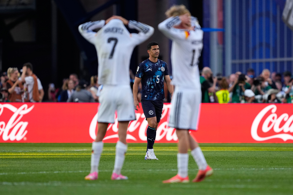 Paraguay's Fabian Balbuena (5) looks on as German players react during a penalty shootout at the end of the World Cup round of 32 soccer match between Germany and Paraguay in Foxborough, Mass., near Boston, Monday, June 29, 2026. (AP Photo/Petr David Josek)