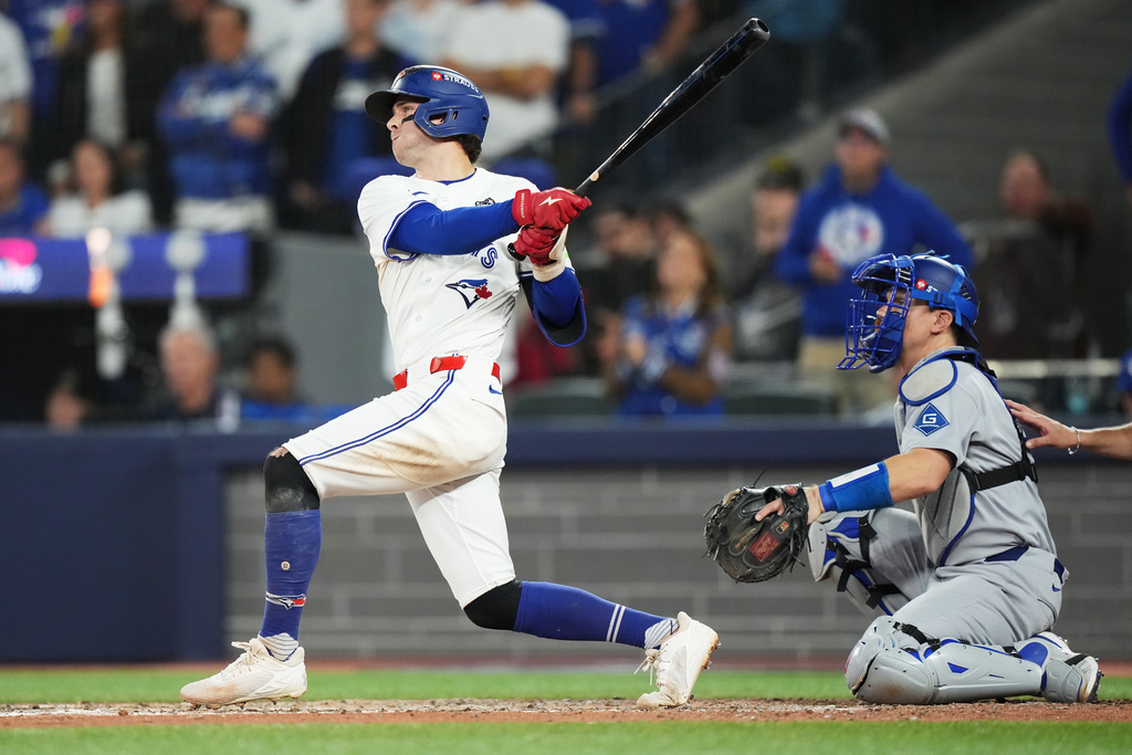 Toronto Blue Jays' Ernie Clement hits a double against the Los Angeles Dodgers during the eighth inning in Game 7 of baseball's World Series in Toronto on Saturday, Nov. 1, 2025. (Nathan Denette/The Canadian Press via AP)