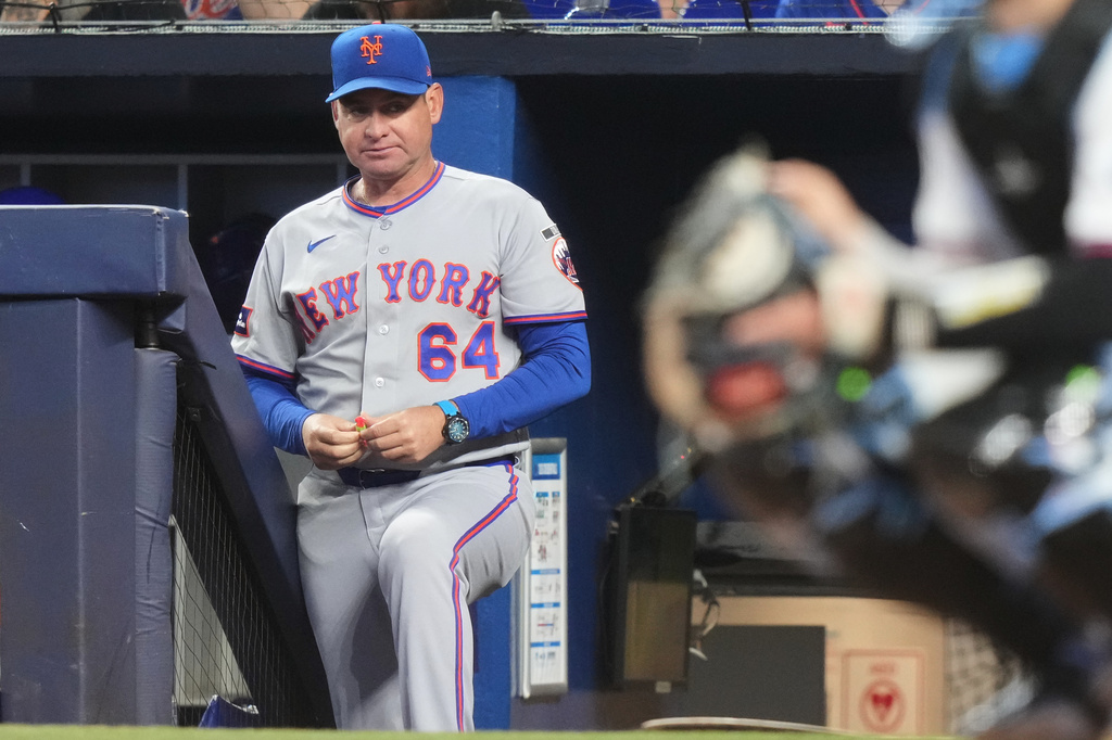 FILE - New York Mets manager Carlos Mendoza (64) watches during the first inning of a baseball game against the Miami Marlins, Saturday, May 23, 2026, in Miami. (AP Photo/Lynne Sladky, File)