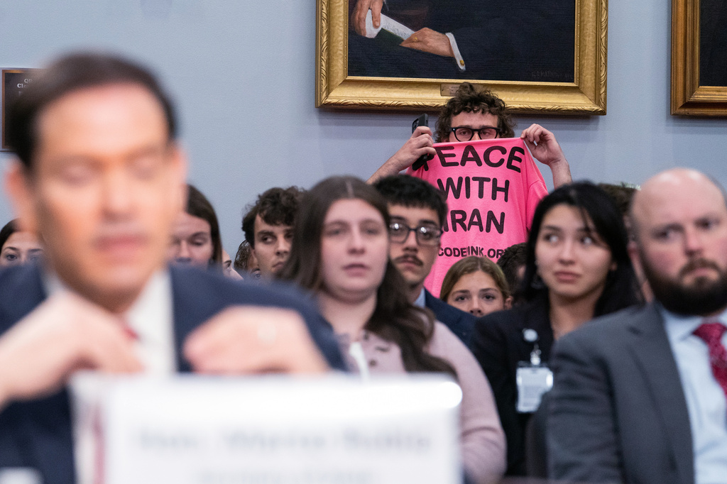 A protester interrupts Secretary of State Marco Rubio's testimony before the House Appropriations Committee, Tuesday, June 2, 2026 in Washington. (AP Photo/Allison Robbert)