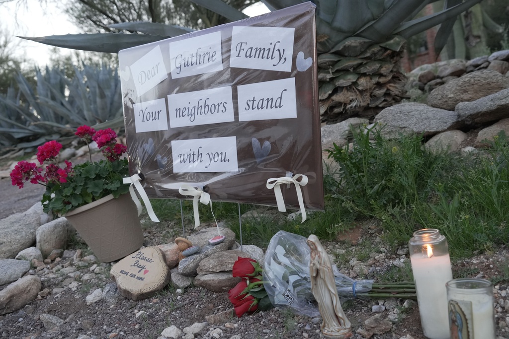 A small vigil grows near Nancy Guthrie‘s house, Monday, Feb. 9, 2026 in Tucson, Ariz. (AP Photo/Ty ONeil)