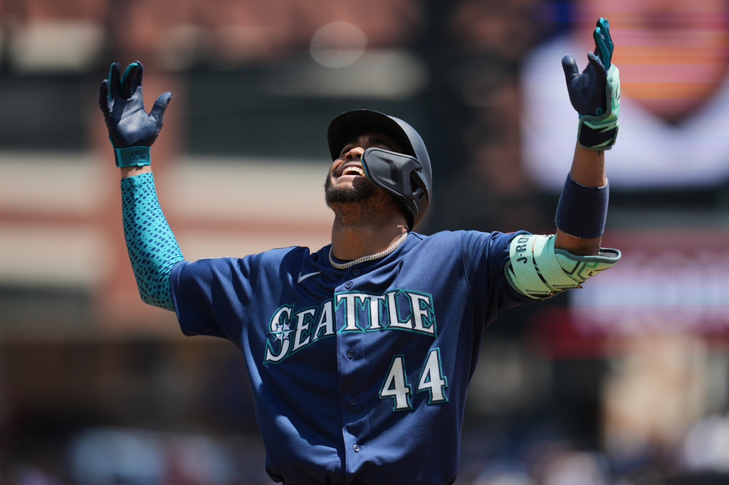 Seattle Mariners' Julio Rodríguez reacts to hitting a single against the Detroit Tigers during the third inning of a baseball game Saturday, June 6, 2026, in Detroit. (AP Photo/Paul Sancya)