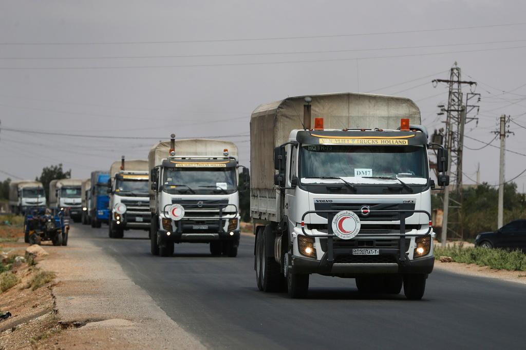 FILE - A convoy of vehicles loaded with food and other aid is en route to Sweida on the international highway in rural Daraa province, Syria, July 20, 2025, heading to the city of Busra al-Sham. (AP Photo/Omar Sanadiki, File)