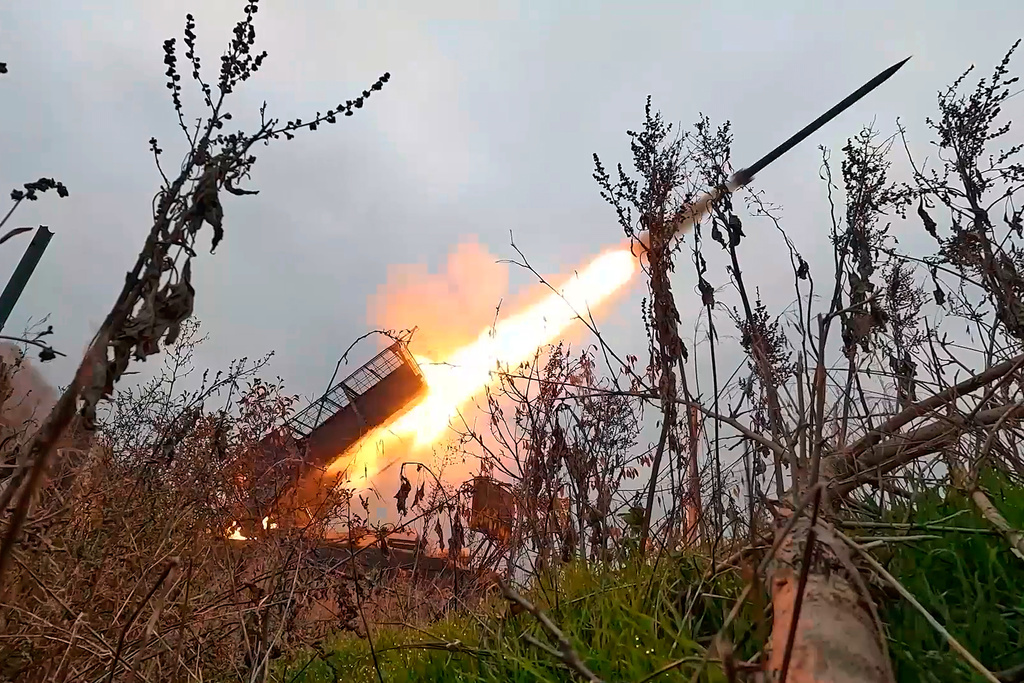 In this image made from video provided by Russian Defense Ministry Press Service on Wednesday, Nov. 12, 2025, a Russian "Grad" self-propelled 122 mm multiple rocket launcher fires towards Ukrainian positions on an undisclosed location in Ukraine. (Russian Defense Ministry Press Service via AP)