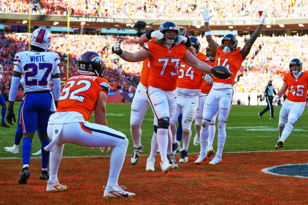 Denver Broncos offensive tackle Frank Crum (73) celebrates with teammates after a touchdown during the first half of an NFL divisional round playoff football game against the Buffalo Bills, Saturday, Jan. 17, 2026, in Pittsburgh. (AP Photo/Jack Dempsey)