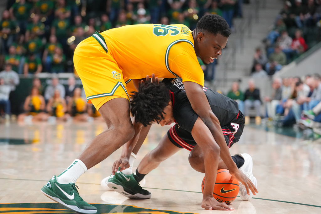 Baylor center James Nnaji, left, and Texas Tech guard Christian Anderson compete for a loose ball during the first half of an NCAA college basketball game Tuesday, Jan. 20, 2026, in Waco, Texas. (AP Photo/Julio Cortez)
