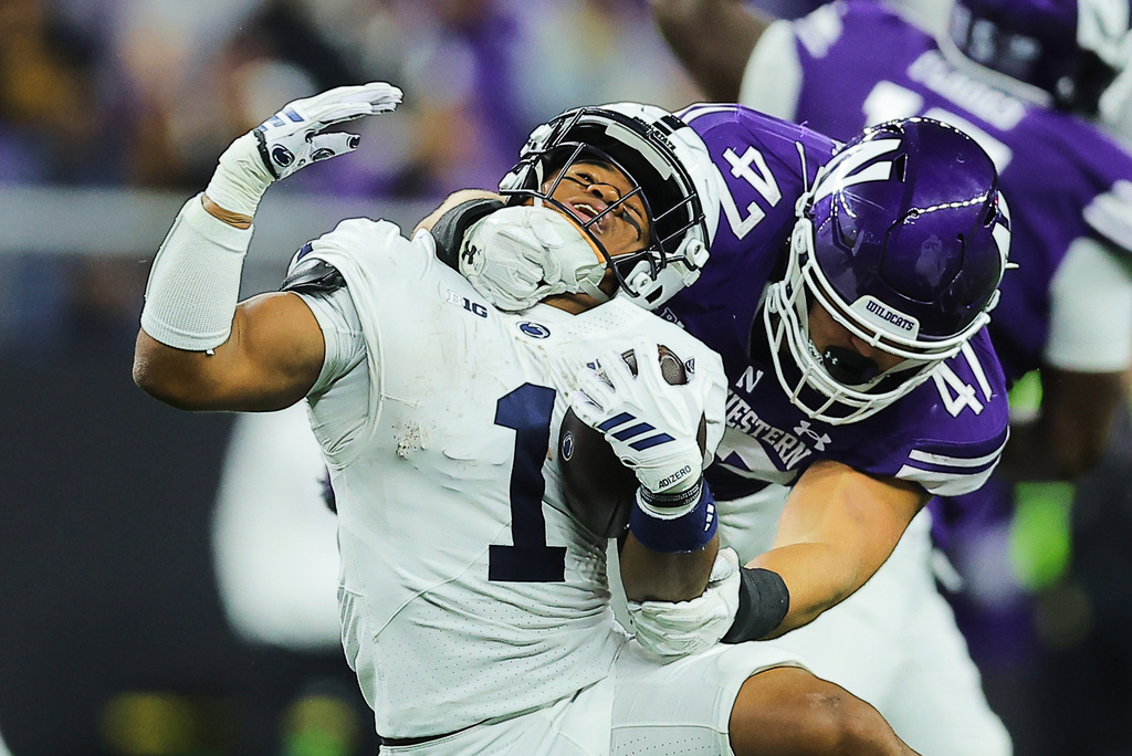 Northwestern linebacker Max Mohring (47) tackles Penn State running back James Peoples, left, during the first half of an NCAA college football game in Evanston, Ill., Friday, Oct. 2, 2026. (AP Photo/Melissa Tamez)