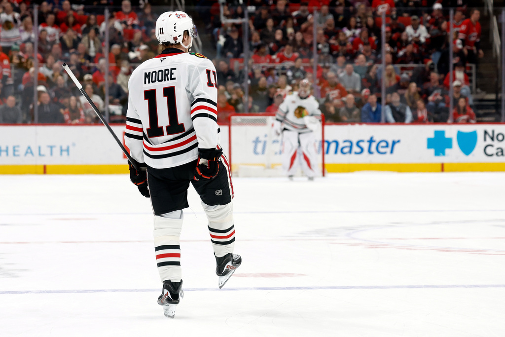 Chicago Blackhawks' Oliver Moore (11) celebrates after his winning shootout goal against the Carolina Hurricanes in an NHL hockey game in Raleigh, N.C., Thursday, Jan. 22, 2026. (AP Photo/Karl DeBlaker)