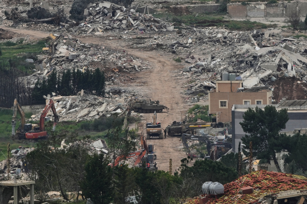 Israeli army vehicles and bulldozers operate in southern Lebanon, as seen from northern Israel, Wednesday, April 15, 2026. (AP Photo/Ariel Schalit)