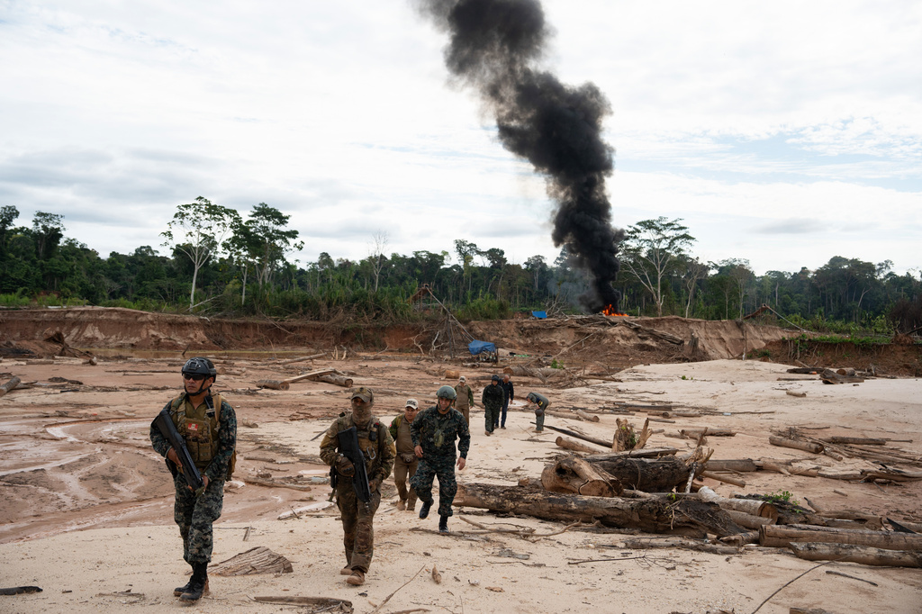 Members of the Peruvian Navy destroy a dredge used for illegal mining near the Malinowski River in the Tambopata National Reserve in Puerto Maldonado, Peru, Tuesday, Aug. 11, 2026. (AP Photo/Guadalupe Pardo)