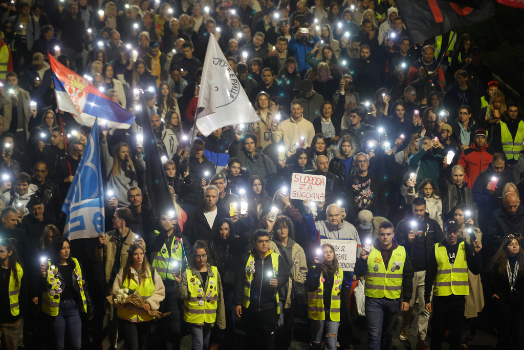 People march during a protest in Belgrade, Serbia, Wednesday, Oct. 1, 2025, eleven months after the deadly train station tragedy that sparked mass demonstrations against corruption. (AP Photo/Marko Drobnjakovic)