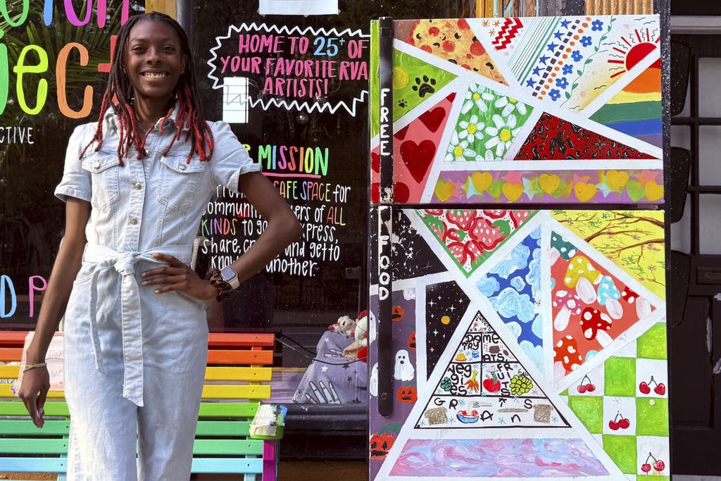 Taylor Scott, founder of RVA Community Fridges, poses with one of her fridges on E. Main Street in Richmond on Sunday, Sept. 14, 2025. (Taylor Scott/RVA Community Fridges via AP)