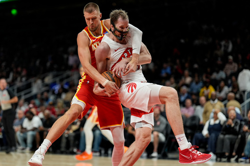 Atlanta Hawks center Kristaps Porzingis (8) and Toronto Raptors center Jakob Poeltl (19) vie for a loose ball during the second half of an NBA basketball game, Wednesday, Oct. 22, 2025, in Atlanta. (AP Photo/Mike Stewart) Atlanta Hawks center Kristaps Porzingis (8) and Toronto Raptors center Jakob Poeltl (19) vie for a loose ball during the second half of an NBA basketball game, Wednesday, Oct. 22, 2025, in Atlanta. (AP Photo/Mike Stewart)