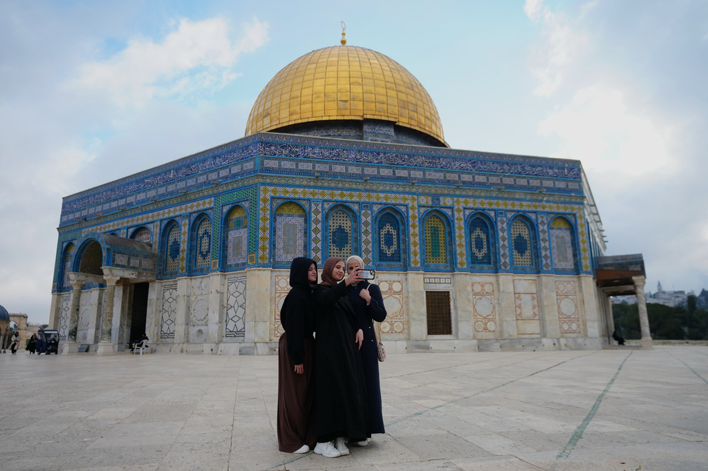 A Muslim women take a selfie next to the Dome of Rock shrine at Al-Aqsa Mosque compound following a ceasefire reached between Iran, Israel and the United States. in Jerusalem's Old City, Thursday, April 9, 2026. (AP Photo/Mahmoud Illean)