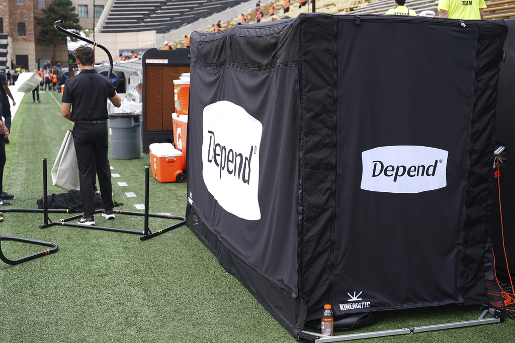A tent equipped with a bathroom is set up in the team box on the Colorado sideline before the team hosts Georgia Tech in an NCAA college football game Friday, Aug. 29, 2025, in Boulder, Colo. (AP Photo/David Zalubowski)
