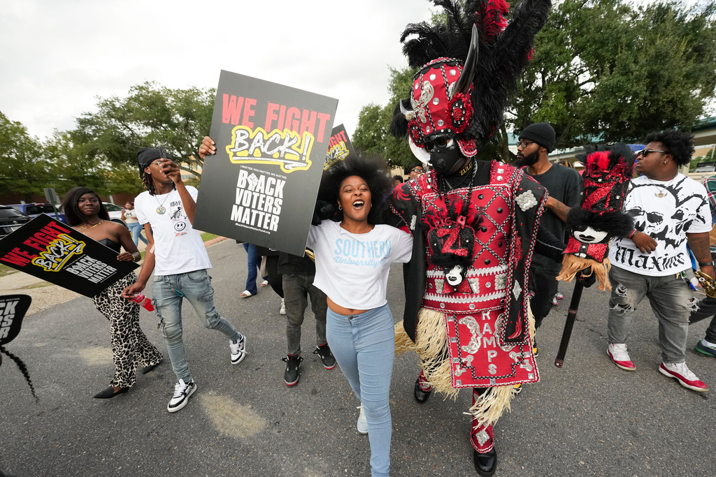 FILE - Students and a member of the Zulu Tramps march to a campus polling place on Election Day at Southern University in Baton Rouge, La., Nov. 5, 2024. (AP Photo/Gerald Herbert, File)