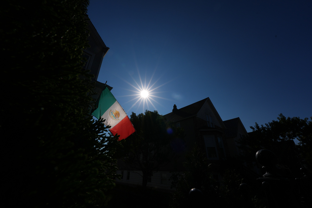 A Mexican flag hangs at a home in Chicago's Logan Square neighborhood, Thursday, Oct. 16, 2025. (AP Photo/Rebecca Blackwell)