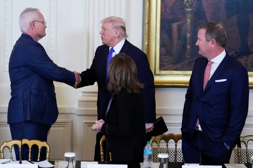 President Donald Trump speaks with Chief Executive Officer and Chairman of ExxonMobil Darren Woods, left, while Chairman, President and Chief Executive Officer of Marathon Petroleum Maryann Mannen, right, and Tallgrass Energy President and Chief Executive Officer Matt Sheehy, far right, look on during a meeting with oil executives in the East Room of the White House, Friday, Jan. 9, 2026, in Washington. (AP Photo/Alex Brandon)