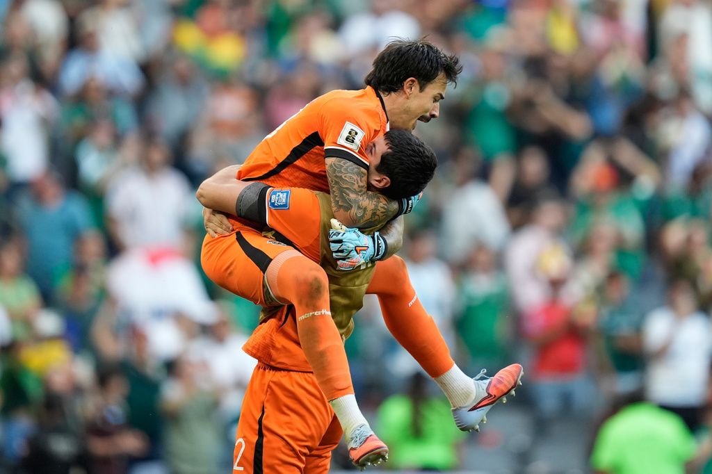 Bolivia's goalkeeper Guillermo Viscarra, top, and goalkeeper Carlos Lampe celebrate at the end of a World Cup playoff semifinal soccer match between Bolivia and Suriname in Monterrey, Mexico, Thursday, March 26, 2026. (AP Photo/Fernando Llano)