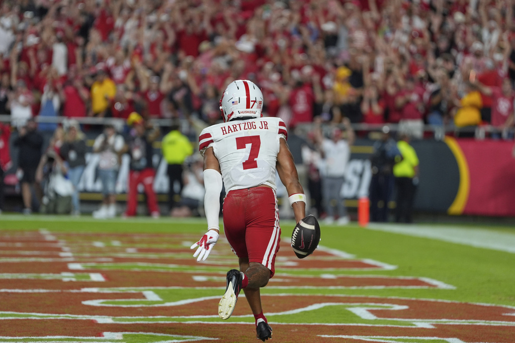 Nebraska defensive back Malcolm Hartzog Jr. (7) celebrates after intercepting a pass intended for Cincinnati wide receiver Caleb Goodie (10) during the second half of an NCAA college football game Friday, Aug. 29, 2025, at Arrowhead Stadium in Kansas City, Mo. (AP Photo/Charlie Riedel)