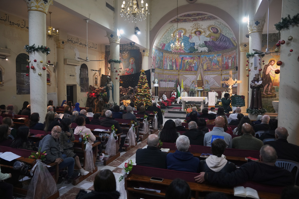 Palestinian Christians attend Mass on Christmas Eve at the Holy Family Catholic Church in Gaza City, Wednesday, Dec. 24, 2025. (AP Photo/Jehad Alshrafi)