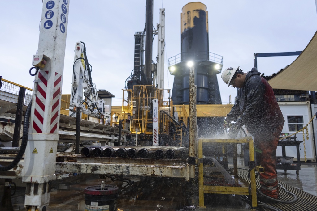 Drilling team member Lalo Aguilar works on inner tubes during an Expedition 501 wireline core drilling operation aboard the Liftboat Robert platform, in the North Atlantic, Sunday, July 20, 2025. (AP Photo/Carolyn Kaster)