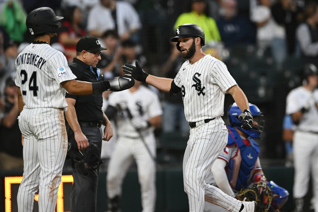 Chicago White Sox's Tristan Peters, right, celebrates with teammate Braden Montgomery (24) after hitting a two-run home run during the second inning of a baseball game against the Texas Rangers in Chicago, Monday, Aug. 24, 2026. (AP Photo/Paul Beaty)