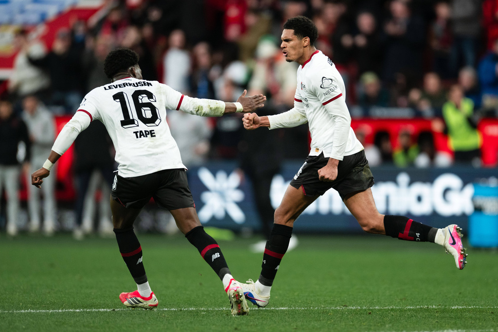 Bayer's Jarell Quansah, right, celebrates with Axel Tape after scoring his side's first goal during the German Bundesliga soccer match between Bayer Leverkusen and FSV Mainz 05, in Leverkusen, Germany, Saturday, Feb. 28, 2026. (Marius Becker/dpa via AP)