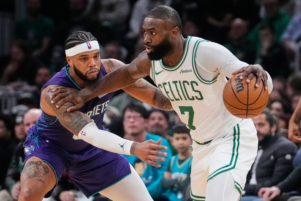 Boston Celtics guard Jaylen Brown (7) pushes Charlotte Hornets forward Miles Bridges, left, on a drive to the basket during the first half of an NBA basketball game, Wednesday, March 4, 2026, in Boston. (AP Photo/Charles Krupa)