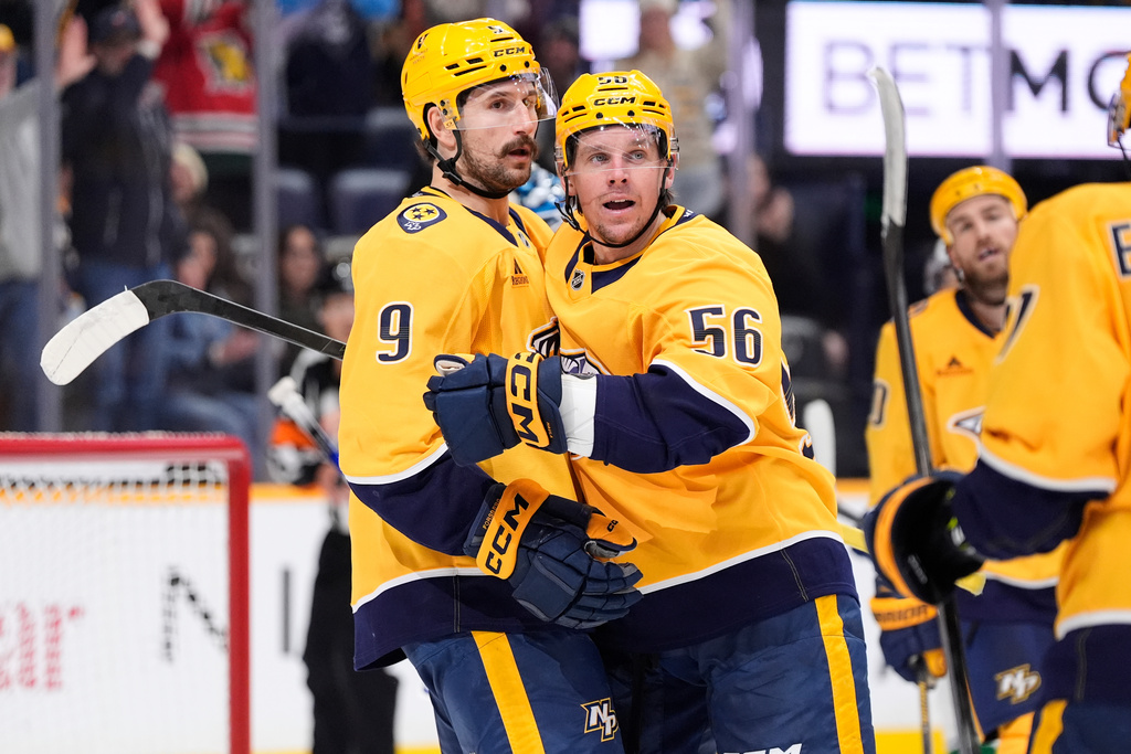 Nashville Predators left wing Filip Forsberg (9) congratulates left wing Erik Haula (56) after his goal during the second period of an NHL hockey game against the Vancouver Canucks, Monday, Nov. 3, 2025, in Nashville, Tenn. (AP Photo/George Walker IV)