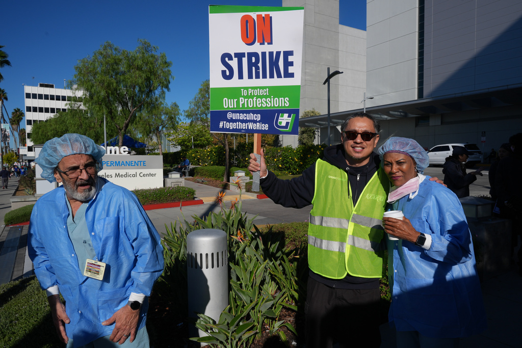Kaiser Permanente healthcare workers are greeted by striking union members in front of the Los Angeles Kaiser Medical Center in Los Angeles, Wednesday, Oct. 15, 2025. (AP Photo/Damian Dovarganes)
