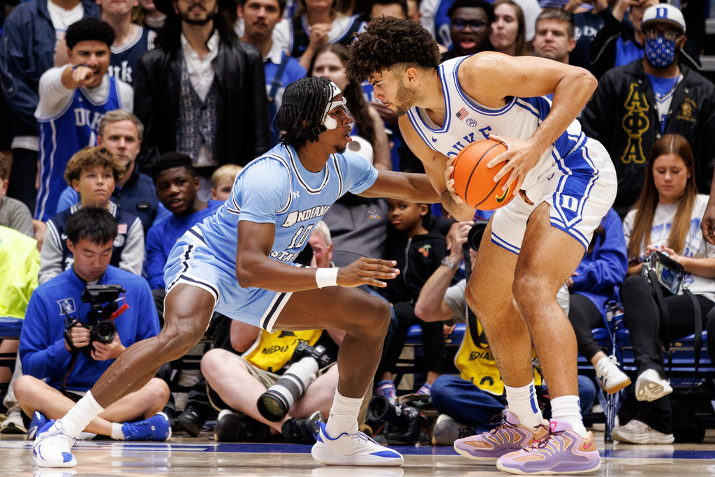 Duke's Cameron Boozer, right, holds the ball as Indiana State's Enel St. Bernard (10) defends during the first half of an NCAA college basketball game in Durham, N.C., Friday, Nov. 14, 2025. (AP Photo/Ben McKeown)