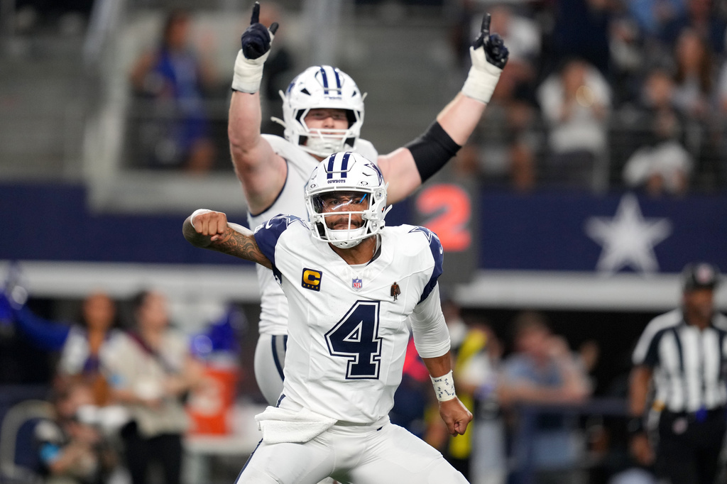 Dallas Cowboys quarterback Dak Prescott (4) celebrates after throwing a pass for a touchdown against the Washington Commanders in the second half during an NFL football game in Arlington, Texas, Sunday, Sept. 20, 2026. (AP Photo/Tony Gutierrez)