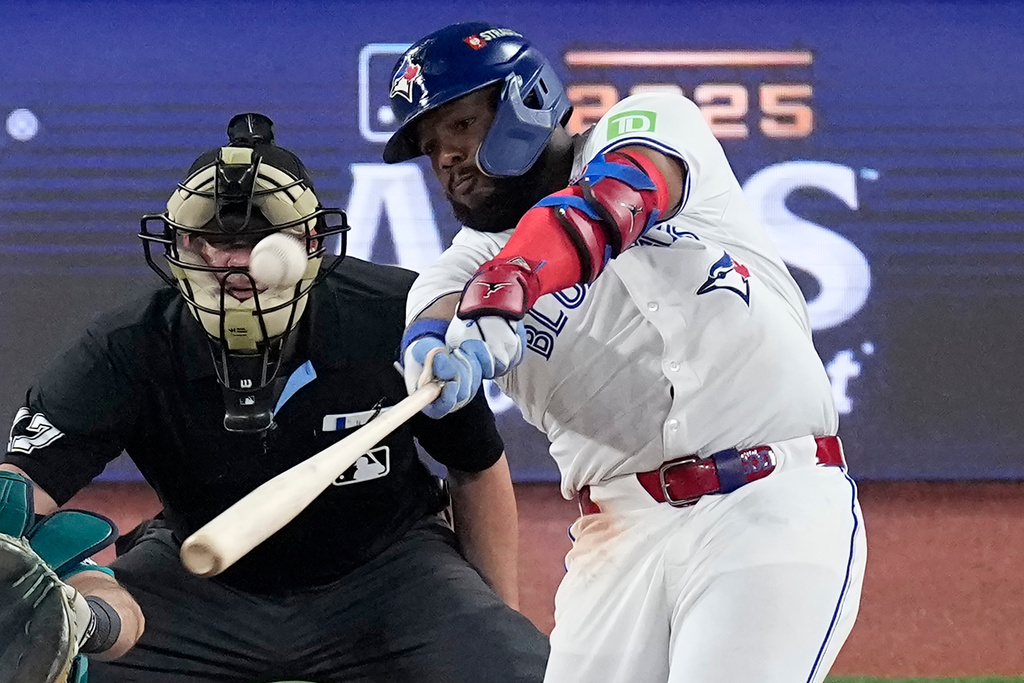 Toronto Blue Jays' Vladimir Guerrero Jr. connects for a solo home run against the Seattle Mariners during the fifth inning in Game 6 of baseball's American League Championship Series, Sunday, Oct. 19, 2025, in Toronto. (AP Photo/David J. Phillip)