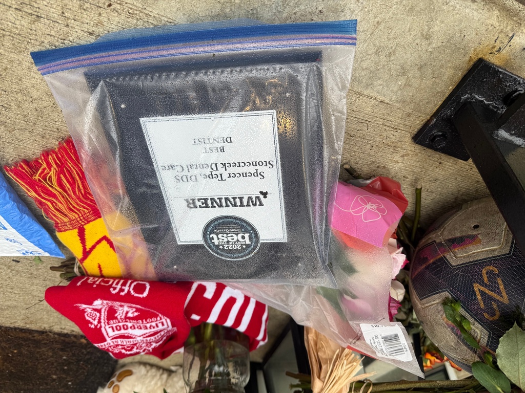 Flowers and other items sit on the front porch of Spencer and Monique Tepe's home in Columbus, Ohio, on Tuesday, Jan. 6, 2026. (AP Photo/Patrick Aftoora-Orsagos)