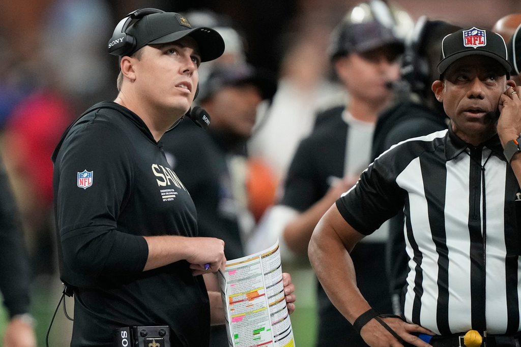 New Orleans Saints head coach Kellen Moore watches a replay in the first half of an NFL football game against the New York Giants, Sunday, Oct. 5, 2025, in New Orleans. (AP Photo/Gerald Herbert)