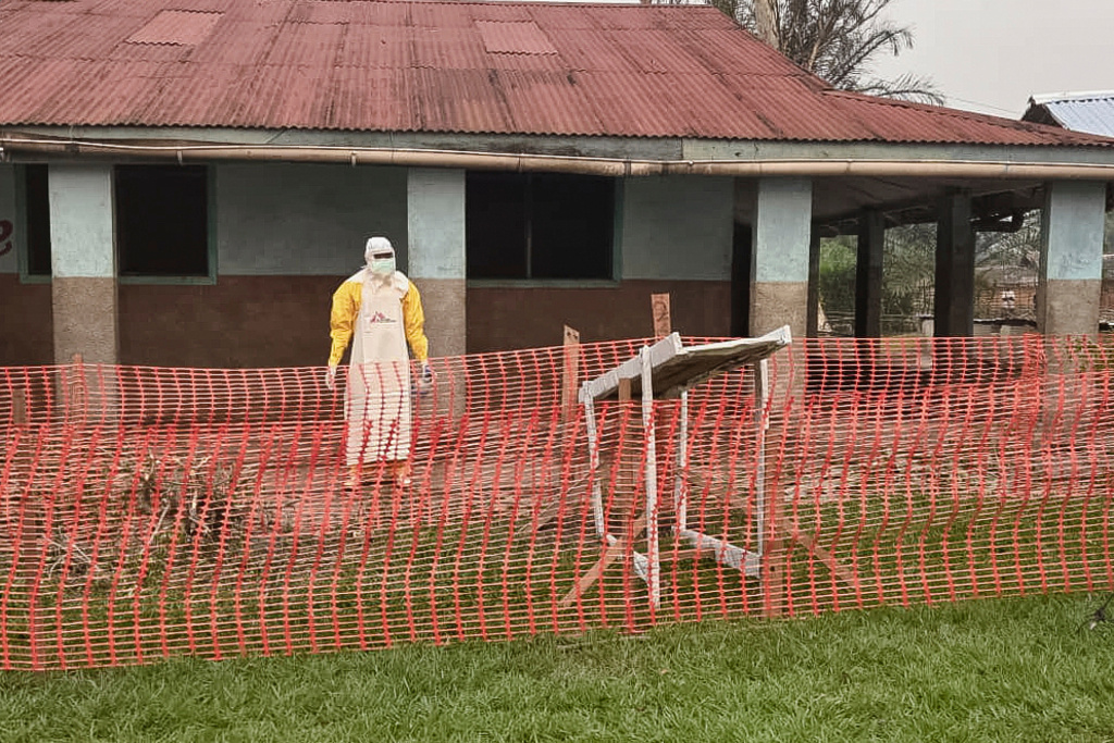 In this photo provided by Doctors Without Borders, a man wearing protective clothing stands outside an Ebola treatment center in the remote Bulape Health Zone, Kasaï province, the Democratic Republic of Congo, Sunday, Sept 7, 2025, that was set up following the outbreak of the Zaire strain of the Ebola virus. (MSF via AP)