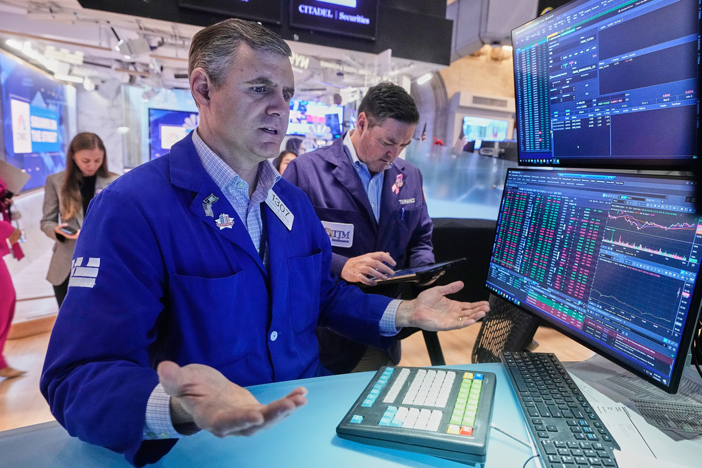Specialist Thomas Schreck, foreground, works at his post on the floor of the New York Stock Exchange, Wednesday, Nov. 5, 2025. (AP Photo/Richard Drew)