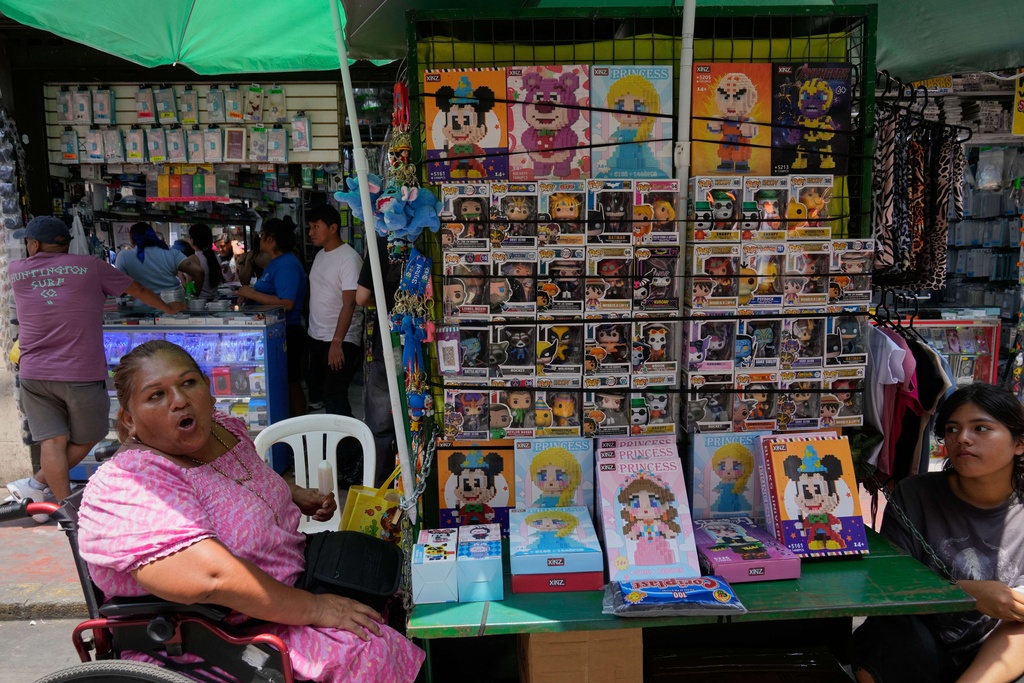 A vendor sells toys imported from China in downtown Lima, Peru, Saturday, Jan. 31, 2026. (AP Photo/Martin Mejia)