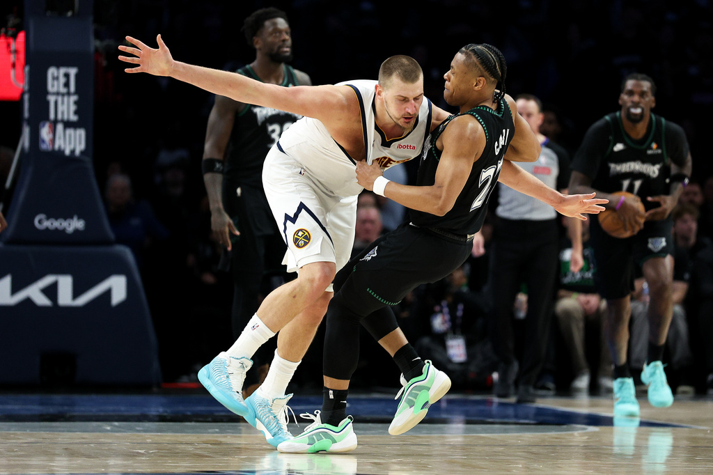 Denver Nuggets center Nikola Jokic, left, and Minnesota Timberwolves guard Jaylen Clark (22) get into an altercation during the second half of Game 6 of a first-round NBA basketball playoffs series, Thursday, April 30, 2026, in Minneapolis. (AP Photo/Matt Krohn)
