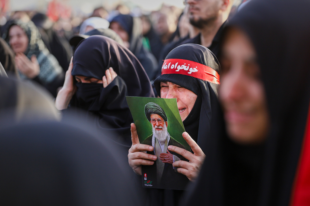 A woman weeps while holding a picture of the late Iranian Supreme Leader Ayatollah Ali Khamenei as mourners gather for the funeral procession in Qom, the heart of religious studies in Iran, Tuesday, July 7, 2026.(Mohammad Asadi/ISNA via AP)