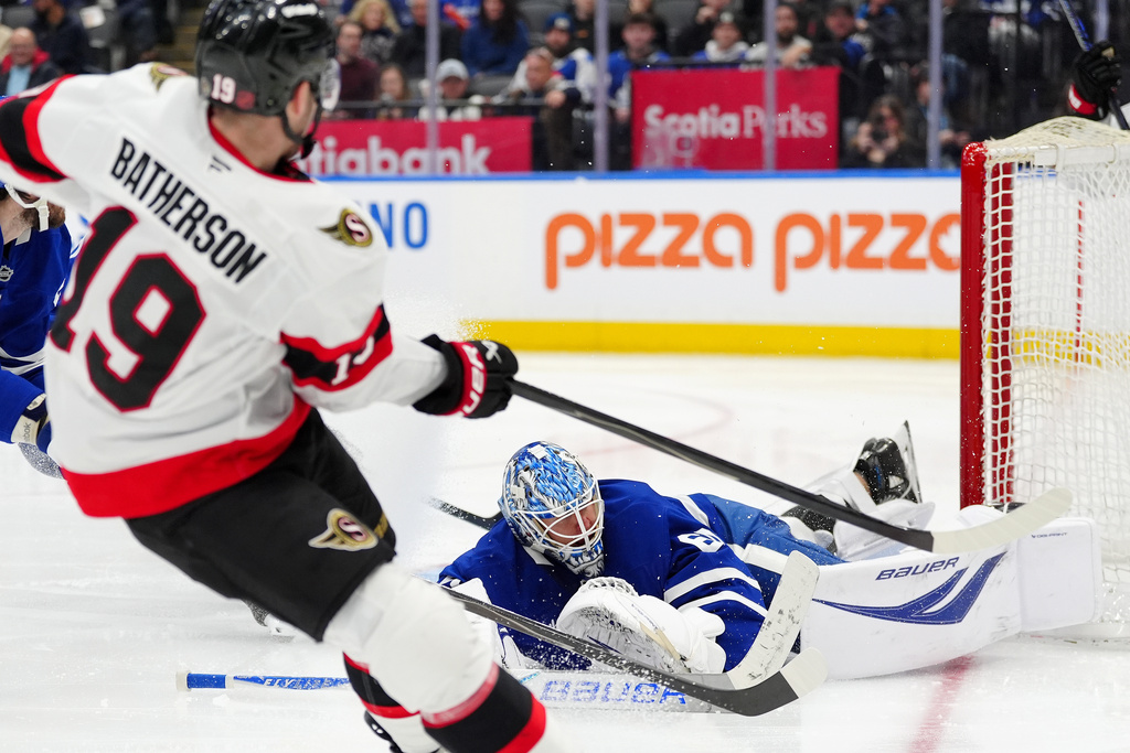 Ottawa Senators right wing Drake Batherson (19) scores on Toronto Maple Leafs goaltender Joseph Woll during the third period of an NHL hockey game in Toronto, Saturday, Dec. 27, 2025. (Frank Gunn/The Canadian Press via AP)
