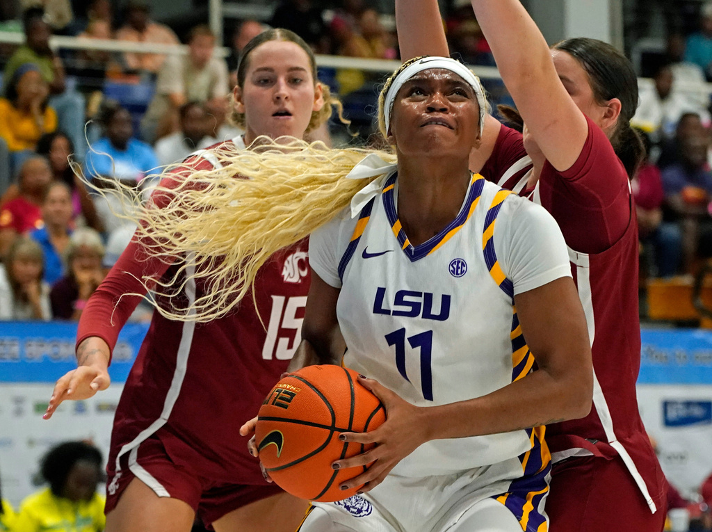 LSU guard ZaKiyah Johnson, center, drives for a shot between Washington State defenders Keandra Koorits, left, and Malia Ruud during the first quarter of their Reef Division championship game at the Paradise Jam NCAA college basketball tournament in St. Thomas, U.S. Virgin Islands, Saturday, Nov. 29, 2025. (Bill Kiser/Virgin Islands Daily News via AP)