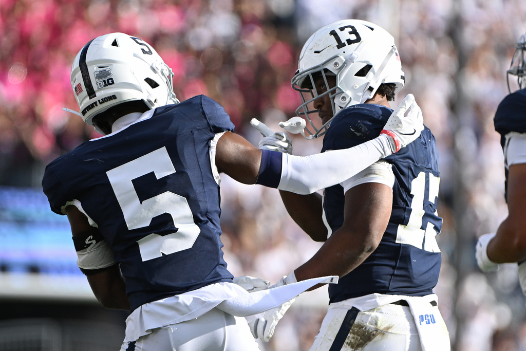 Penn State running back Kaytron Allen (13) celebrates with wide receiver Devonte Ross (5) after scoring a touchdown against Northwestern during the second quarter of an NCAA college football game, Saturday, Oct. 11, 2025, in State College, Pa. (AP Photo/Barry Reeger)