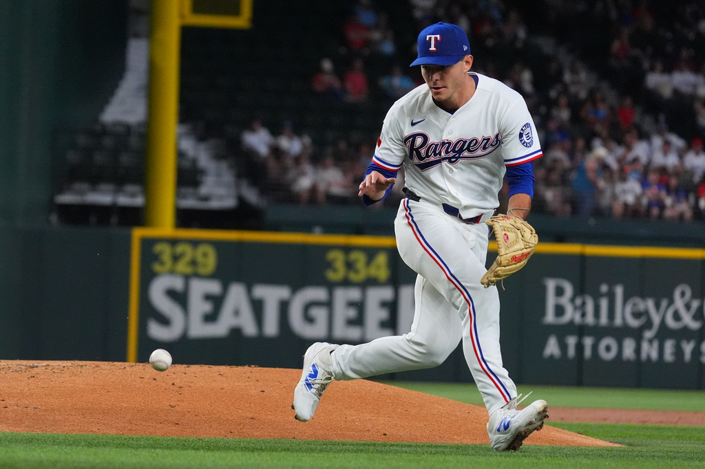 Texas Rangers starting pitcher Jack Leiter fields in groundout hit by Cleveland Guardians' Daniel Schneemann during the third inning of a baseball game, Saturday, June 6, 2026, in Arlington, Texas. (AP Photo/LM Otero)