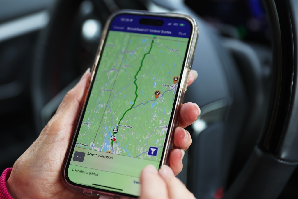 Daphne Dixon shows a map she uses to identify where chargers are located for her electric vehicle Saturday, Oct. 11, 2025, in Ridgefield, Conn. (AP Photo/Heather Khalifa)
